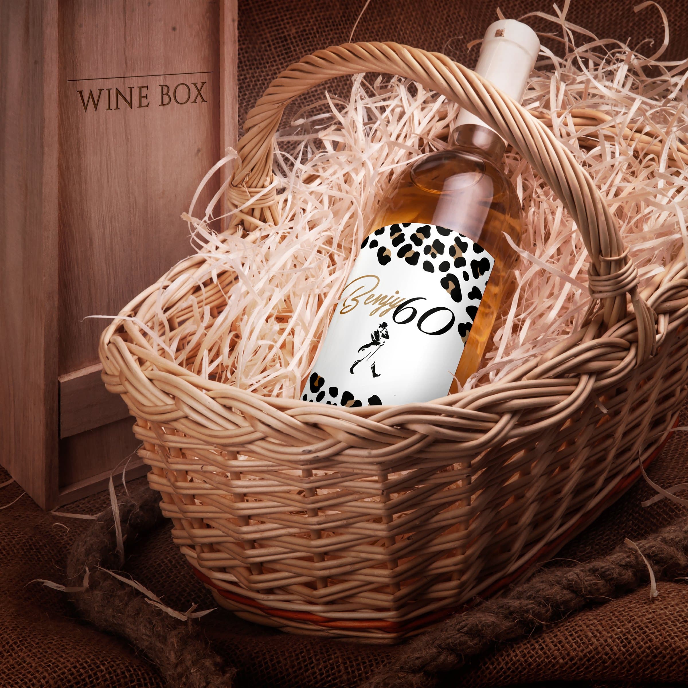 Benjy60 wine bottle nested in a wicker gift basket with wood wool