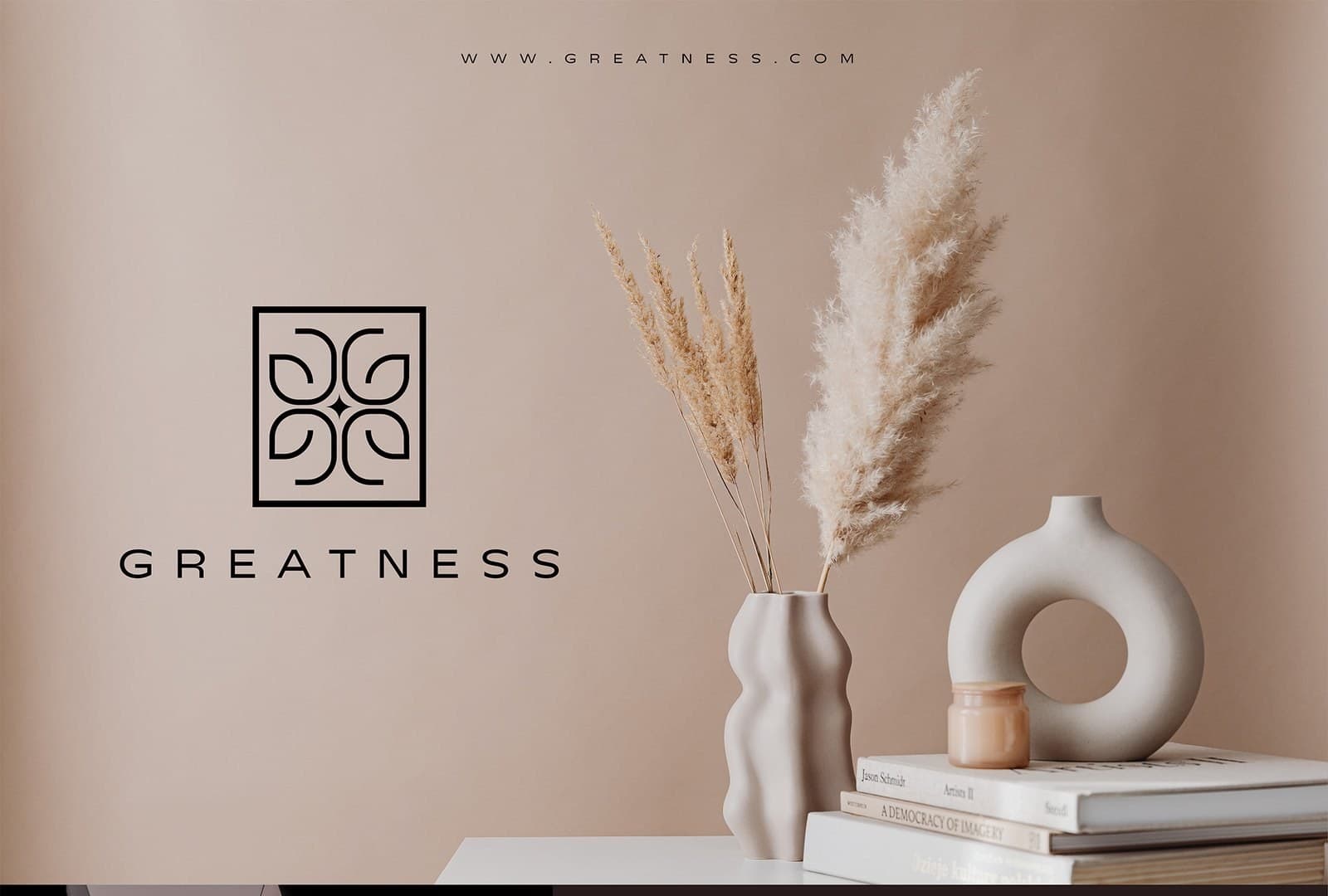Greatness monogram beside pampas grass and ceramic vases in warm beige