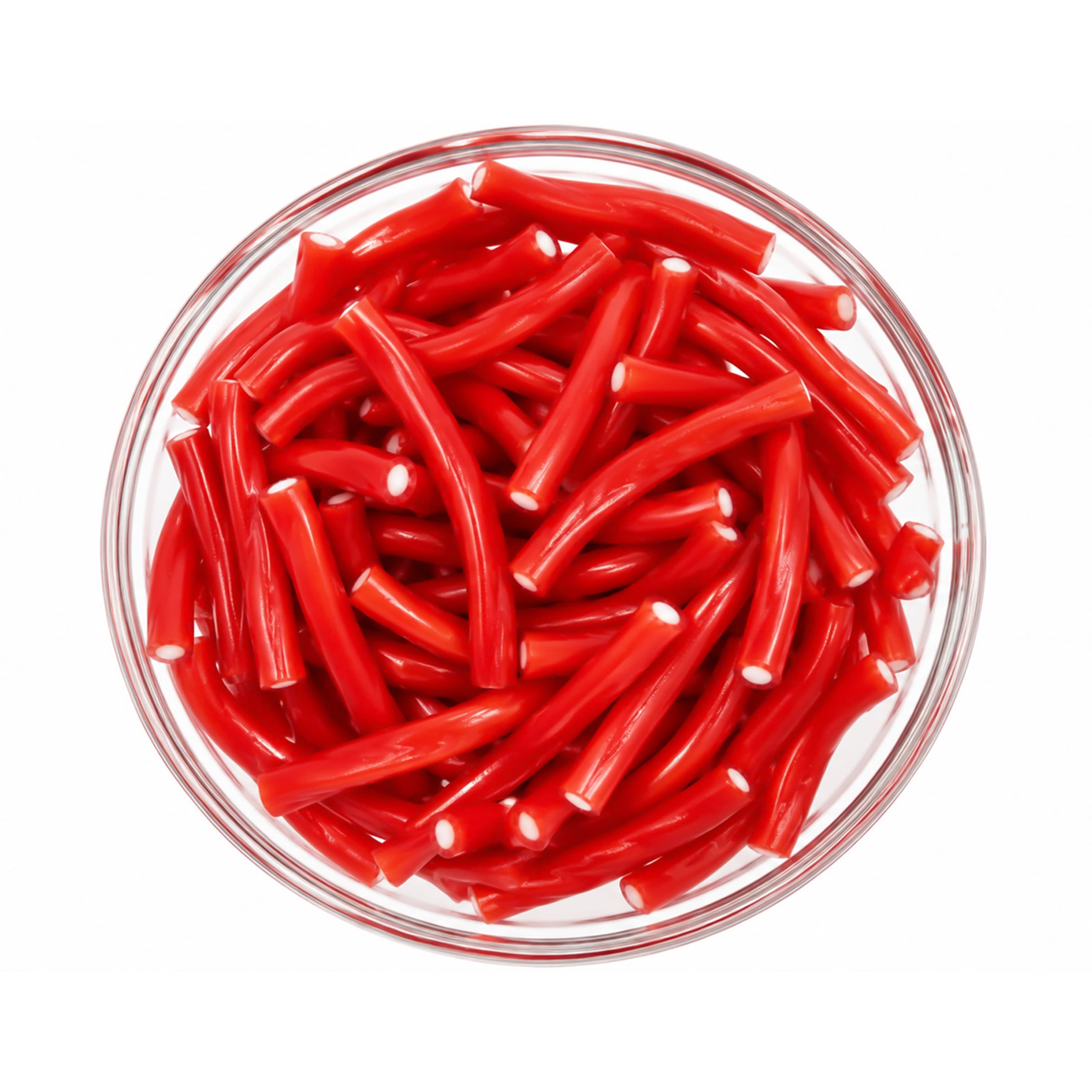 Glass bowl of red licorice ropes photographed from above on white